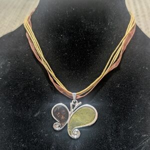 butterfly pendant necklace, likely featuring either real butterfly wings encased